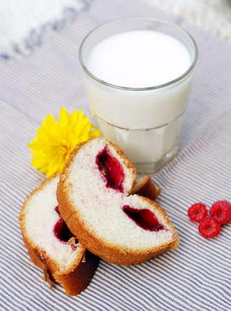 A glass of milk, sweat bake and summer flower on tableclothの写真素材