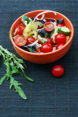 fresh summer salad with cherry tomatoes, basil leaves and other vegetablesの写真素材