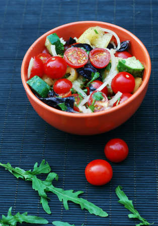 fresh summer salad with cherry tomatoes, basil leaves and other vegetablesの写真素材