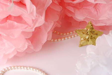 Decorative star, pearl beads and pink and white pom pom.Greeting or invitation card with copyspaceの写真素材