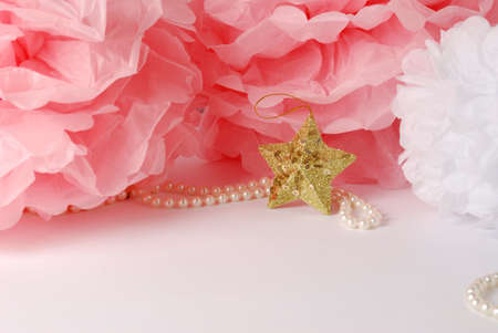 Decorative star, pearl beads and pink and white pom pom.Greeting or invitation card with copyspaceの写真素材