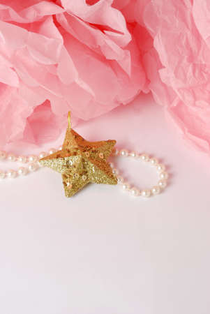 Decorative star, pearl beads and pink and white pom pom.Greeting or invitation card with copyspaceの写真素材