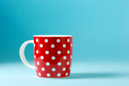 red cup of milk on a blue backgroundの写真素材