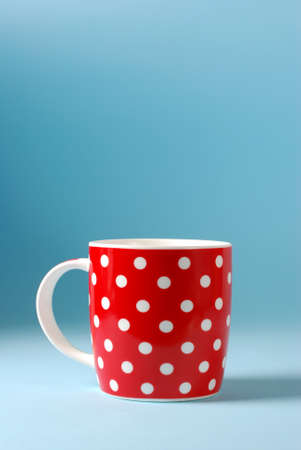 red cup of milk on a blue backgroundの写真素材