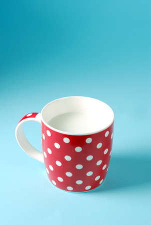 red cup of milk on a blue backgroundの写真素材