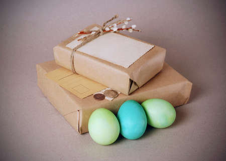 Vintage still life with easter eggs and gift boxes in craft paperの写真素材