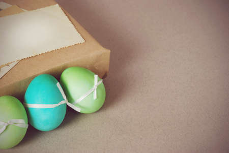 Vintage still life with easter eggs and gift boxes in craft paperの写真素材