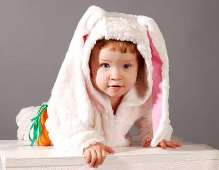 Portrait of a cute little girl dressed in Easter bunny suitの写真素材