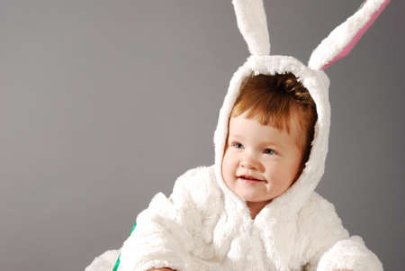 Portrait of a cute little girl dressed in Easter bunny suitの写真素材
