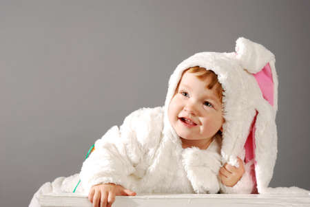 cute little girl dressed in Easter bunny suitの写真素材