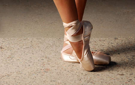 Feet of ballerin dancing in ballet shoesの写真素材