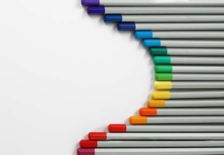 Sharpened monochrome watercolor pencils with multicolor slate-pencil on a white background with space for your title textの写真素材