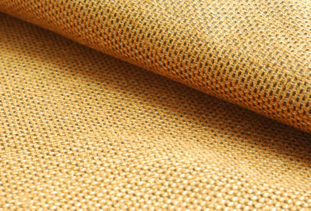 Reddish yellow Chenille fabric waved textile background.の写真素材