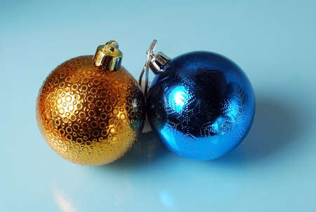 Golden and blue christmass balls on a blue glass background. Seasonal backgroundの写真素材