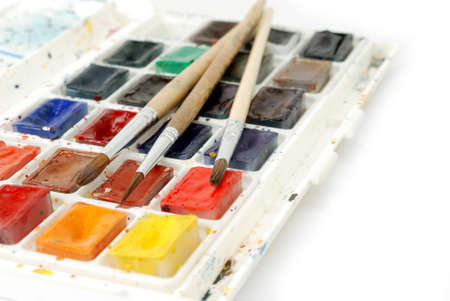 Bright watercolor paints and used brushes for painting. Macro shotの写真素材