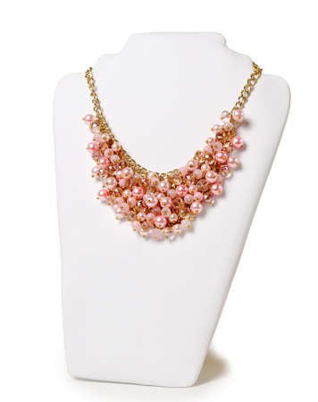 Beautiful pink necklace on a mannequin in front of white backgroundの写真素材