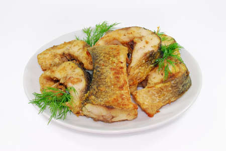 Fried fish, Alaska Pollock or Hake slices on a plate isolatedの写真素材