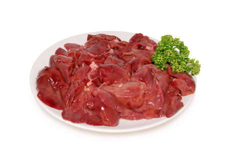 Fresh raw chicken livers on the plate isolatedの写真素材