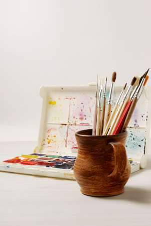 Bright watercolor paints and used brushes for painting. close-up.の写真素材