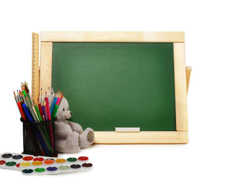 Group of school and office supplies with chalkboard watercolor paints, stack of colored pencils and markers,isolated on whiteの写真素材