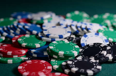 Stack of casino chips on a green background. Poker themeの写真素材
