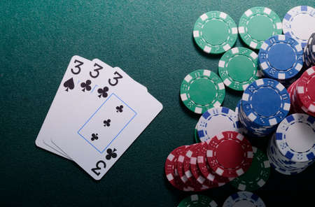 Casino chips and royal flush cards combination on the green table. Poker game themeの写真素材