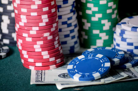close-up casino chips and dollar bills on the poker tableの写真素材