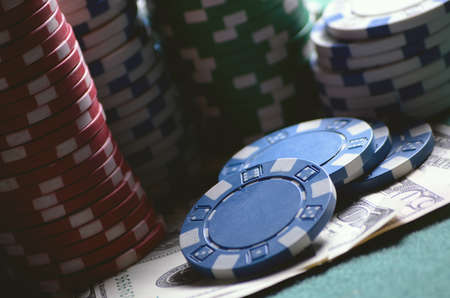 close-up casino chips and dollar bills on the poker tableの写真素材