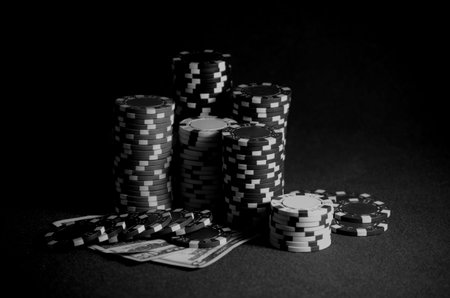 casino chips and dollar bills on the poker tableの写真素材
