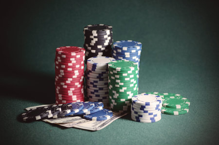 casino chips and dollar bills on the poker table