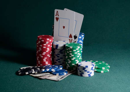 casino chips and dollar bills on the poker tableの写真素材