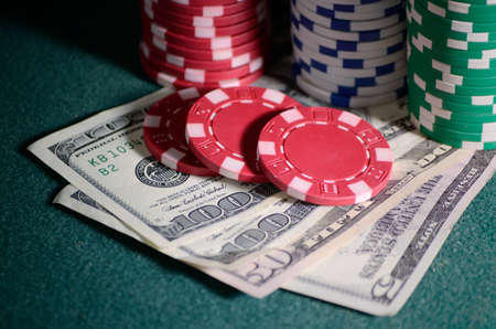 close-up casino chips and dollar bills on the poker tableの写真素材