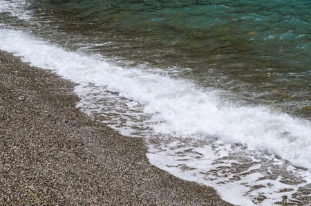 Black Sea coast. Close-up photo of waves on a pebble beach. Marine backgroundの写真素材