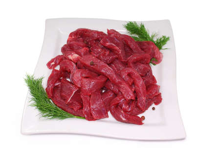 Raw Meat. Uncooked fresh beef slices isolated on white backgroundの写真素材