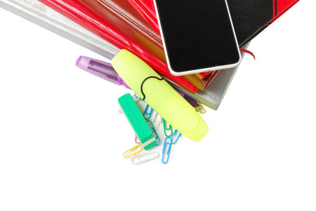 Group of school supplies, books, diaries, with mobile phone on top isolated on white background