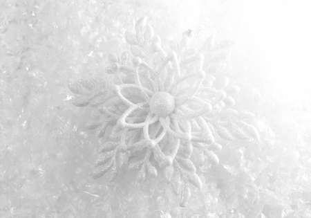 Christmas background with a decorative snowflake and confetti decor on snowの写真素材