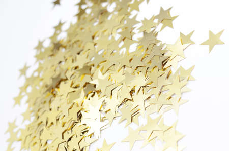 Sparkling gold stars on a white background. Festive seasonal backdropの写真素材