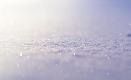 Winter seasonal background. Snow surface close-up with soft focus and bokeh lightsの写真素材