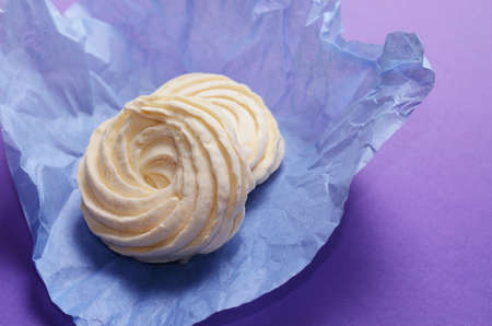 Food Photo of homemade zephyr, marshmallow wrapping paper. Healthy sweet dessert on a pink background.の写真素材