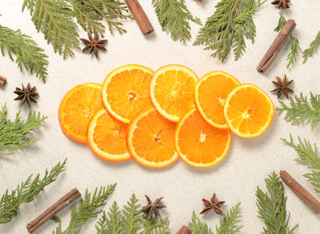 Creative christmas layout made of orange slices, fir tree branches and spices, cinamone, anise stars.の写真素材