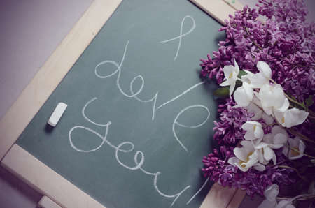 Romantic background with lilac flowers and chalkboardの写真素材