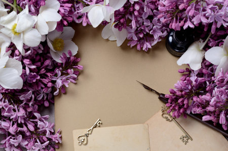 Romantic background with lilac flowers and notebook, sketchbook or diaryの写真素材