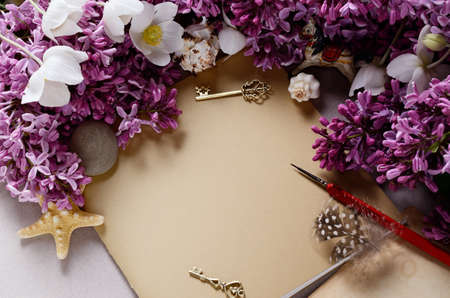 Romantic background with lilac flowers and notebook, sketchbook or diaryの写真素材