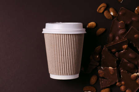 Take away coffee cup. Top view of hot drink and chocolate slices.の写真素材