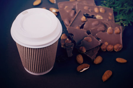 Take away coffee cup. Top view of hot drink and chocolate slices.