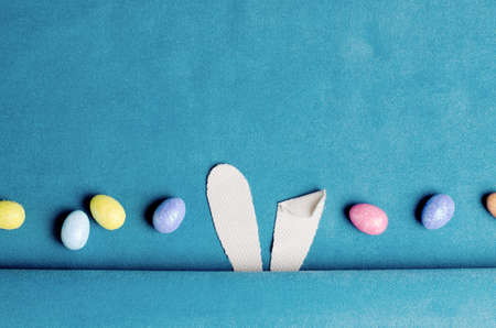 Top view template with Easter bunny ears and colorfull eggs.の写真素材
