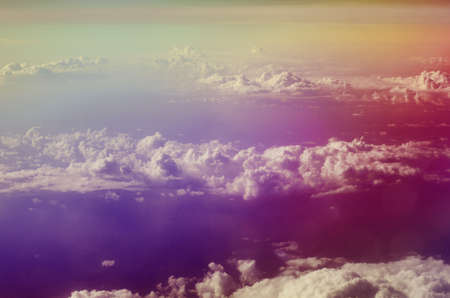 Airplane illuminator view on fluffy clouds and blue sky.の写真素材