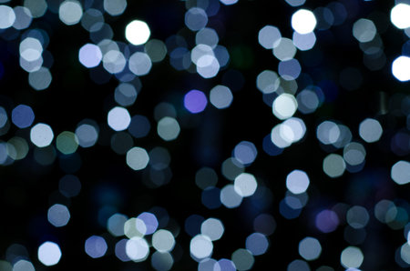 Abstract bokeh of festoon lights on dark background. Christmas and New Year holidays theme...