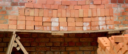 Stack of bricks on the construction territory near future houseの写真素材