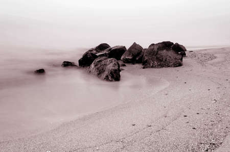 Early morning on the rocky coast of the sea. Smooth water of the sea because of long exposure. Time Pre sunrise, romantic marine wallpaper.の写真素材